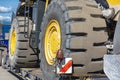 Wheel of a bulldozer close-up on a transport platform. Concept: road construction, heavy construction equipment Royalty Free Stock Photo