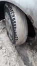 Wheel on car filled by snow winter skidding on ice