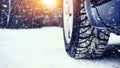 Wheel of a car on a winter road in a blizzard