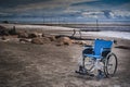 Wheel chair at the beach Royalty Free Stock Photo