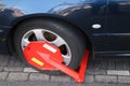 Wheel clamp on the car and will be removed when parking fine is paid in Den Haag, the Netherlands.