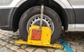 Wheel Clamp on a Poorly Parked Car without Authorization, Blue Zone for Residents Only Royalty Free Stock Photo