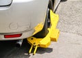 Wheel clamped with yellow clamp on city street