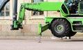 wheel cradle outriggers and levers with hydraulic lift heavy equipment machine that works near the palace