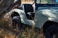 4-wheel drive vehilce parked under a desert tree surrounded by brush