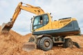 Wheel excavator at sandpit during earthmoving works Royalty Free Stock Photo