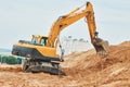 Wheel excavator at sandpit during earthmoving works Royalty Free Stock Photo