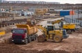 Wheel front-end loader loading sand into dump truck at the construction site Royalty Free Stock Photo