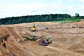 Wheel front-end loader loads sand into a dump truck. Heavy machinery in the mining quarry, excavators and trucks. Mobile jaw Royalty Free Stock Photo