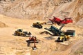 Wheel front-end loader loads sand into a dump truck. Heavy machinery in the mining quarry, excavators and trucks. Mobile jaw Royalty Free Stock Photo