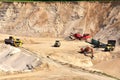Wheel front-end loader loads sand into a dump truck. Heavy machinery in the mining quarry, excavators and trucks. Mobile jaw Royalty Free Stock Photo