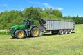 The wheel John Deere 7930 tractor with the trailer