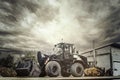 wheel loader on a building yard in the green space office with a gloomy sky Royalty Free Stock Photo