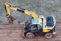 A wheel loader digs the ground at a construction site to pave a road Royalty Free Stock Photo