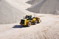 Wheel loader drives in a gravel plant and transports mined sand