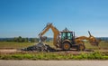 Wheel loader excavator with field background during earthmoving work, construction building Royalty Free Stock Photo