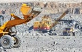 Wheel loader excavator at granite or iron ore opencast mine