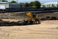 Wheel loader Excavator loading soil at eathmoving works Royalty Free Stock Photo