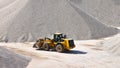 Wheel loader in a gravel pit during mining - heavy construction Royalty Free Stock Photo