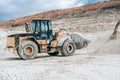 Wheel loader with large bucket on construction site or quarry. Mining heavy machinery details. Earthmoving, excavations Royalty Free Stock Photo