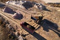 Wheel loader load the sand into dump truck in open pit. Developing the sand in the opencast. Royalty Free Stock Photo