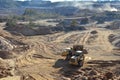 Wheel loader loads sand into heavy mining dump truck at the opencast mining quarry. Heavy machinery in the open pit, excavators,