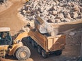 Wheel loader loads tipper with soil Royalty Free Stock Photo