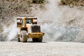 Wheel loader machine loading rocks in the open-mine, Royalty Free Stock Photo