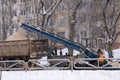 Wheel loader machine removing snow in winter