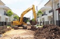 Wheel loader machine unloading clay at moving works in construction site