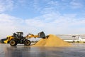 Wheel loader machine unloading paddy rice at rice mill in thailand Royalty Free Stock Photo