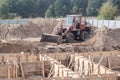 Wheel loader machine unloading soil in earthmoving works at construction site Royalty Free Stock Photo