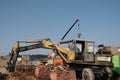 Wheel loader machine unloading soil in earthmoving works at construction site Royalty Free Stock Photo