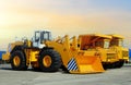 Wheel loader and mining truck. Heavy construction machinery and mining equipment. Front-end loader or all-wheel bulldozer and dump Royalty Free Stock Photo