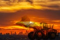 Wheel loader with Silhouette on sunset at city building Royalty Free Stock Photo