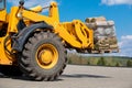 Wheel loader moving cargo green grass lawn rolls