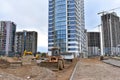 Wheel loader on road building at construction site. Earth-moving heavy equipment for road work. Tower cranes construct of modern Royalty Free Stock Photo