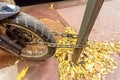 The wheel of the motorcycle is fastened to the pillar by an iron chain