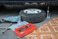 Wheel replacement process: tire on a disk, a set of keys for bolts, a jack Royalty Free Stock Photo