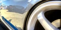 Wheel rim of a shiny white car with blue decal Royalty Free Stock Photo