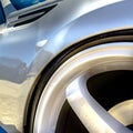 Wheel rim with white spokes on a shiny white car Royalty Free Stock Photo