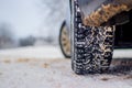 Wheel with spikes on a winter road. Winter road. Snow road. Car on the winter road. Footprints in the snow Royalty Free Stock Photo