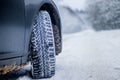 Wheel with spikes on a winter road. Winter road. Snow road. Car on the winter road. Footprints in the snow Royalty Free Stock Photo