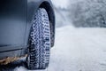 Wheel with spikes on a winter road. Winter road. Snow road. Car on the winter road. Footprints in the snow Royalty Free Stock Photo