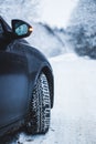 Wheel with spikes on a winter road. Winter road. Snow road. Car on the winter road. Footprints in the snow Royalty Free Stock Photo