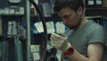 Wheel straightening stand in bicycle workshop. Mechanic uses tool to tension the spokes in rim of velocipede wheel