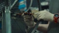 Wheel straightening stand in bicycle workshop. Mechanic uses tool to tension the spokes in rim of velocipede wheel