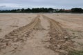 Wheel trace of tractor on the sandy beach. Royalty Free Stock Photo