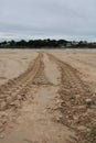 Wheel trace of tractor on the sandy beach. Royalty Free Stock Photo