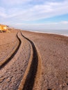 Wheel track of a 4x4 vehicle driving past the beach at sunset Royalty Free Stock Photo